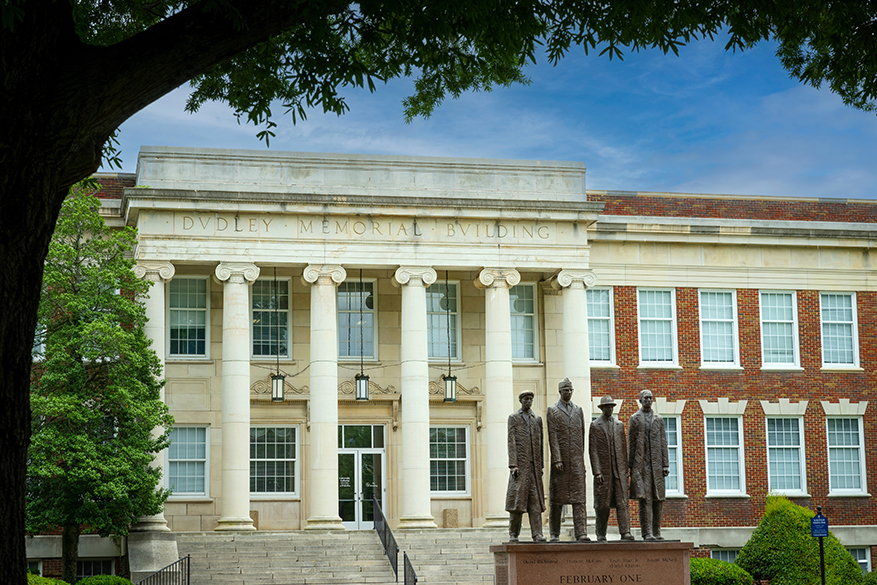 dudley building with A&T Four monument in foreground