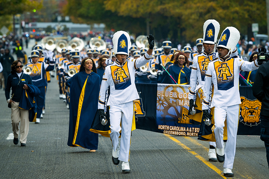Homecoming parade with the Blue and Gold Marching Machine leading the way