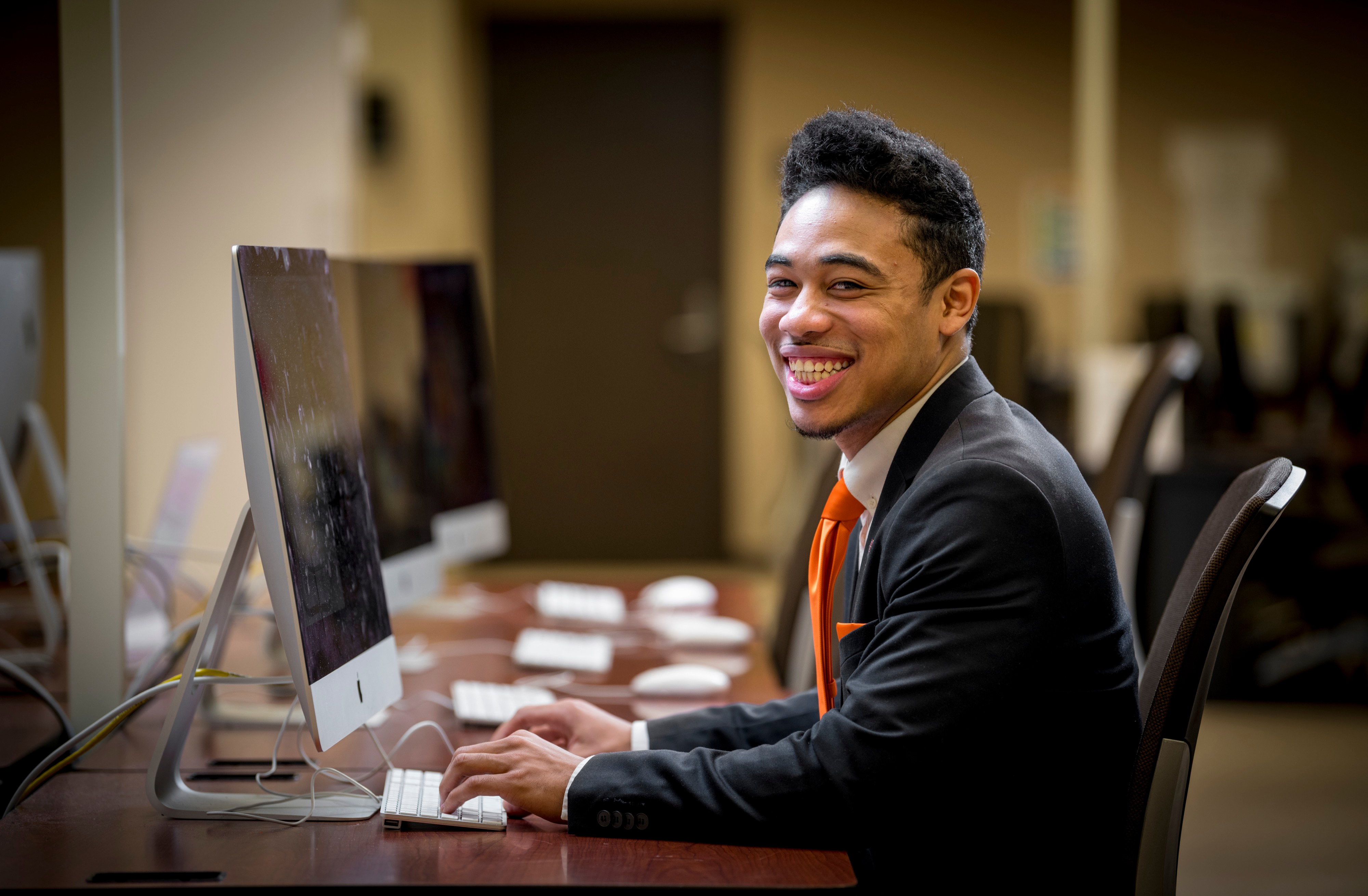 man in business suit at computer