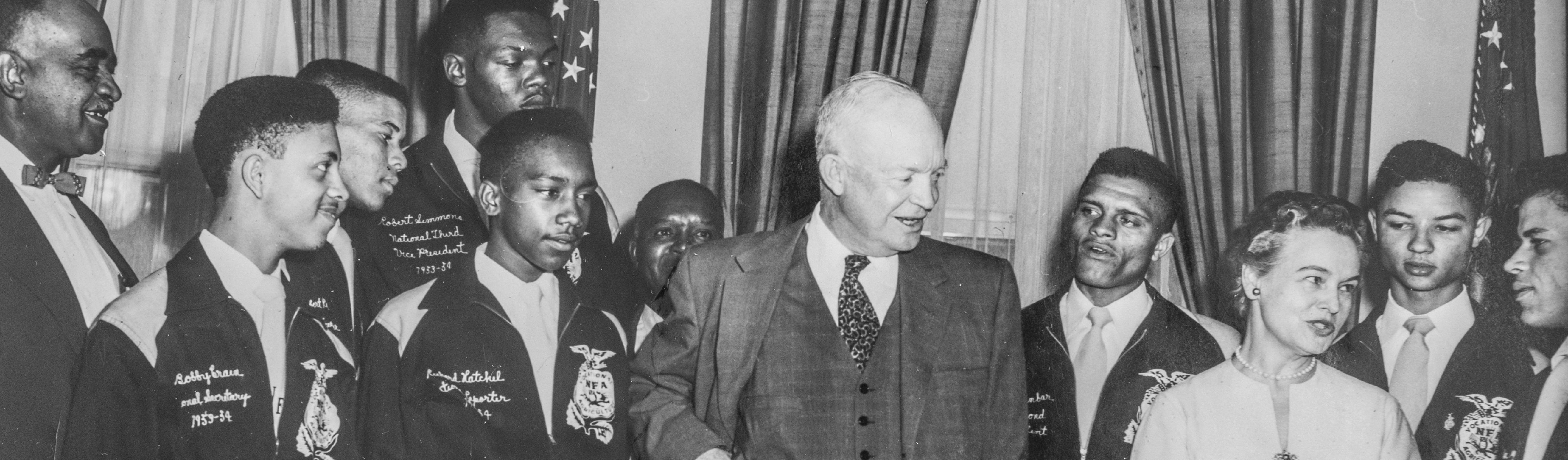 A photograph of President Eisenhower and Oveta Culp Hobby, the first secretary of the U.S. Department of H.E.W., with NFA student officers.