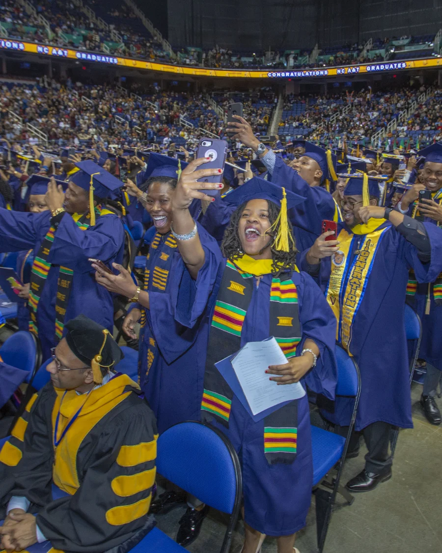 Excited N.C. A&T graduates in caps and gowns celebrate at commencement, holding diplomas and taking selfies. The graphic highlights 14,311 students enrolled in Fall 2024, 95 degree programs, and 2,274 bachelor degrees awarded in 2023–2024.
