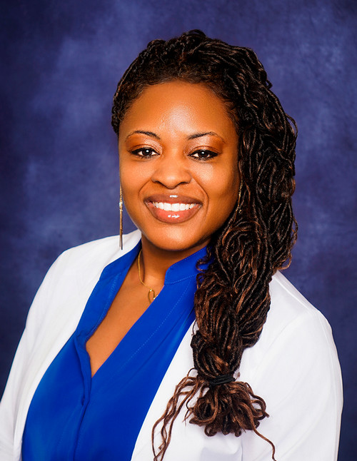 Keyanna Giudry in a professional photo in a lab coat 
