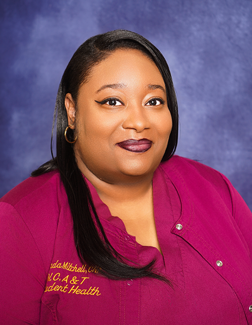 CNA Mitchell in a professional photo with scrubs 
