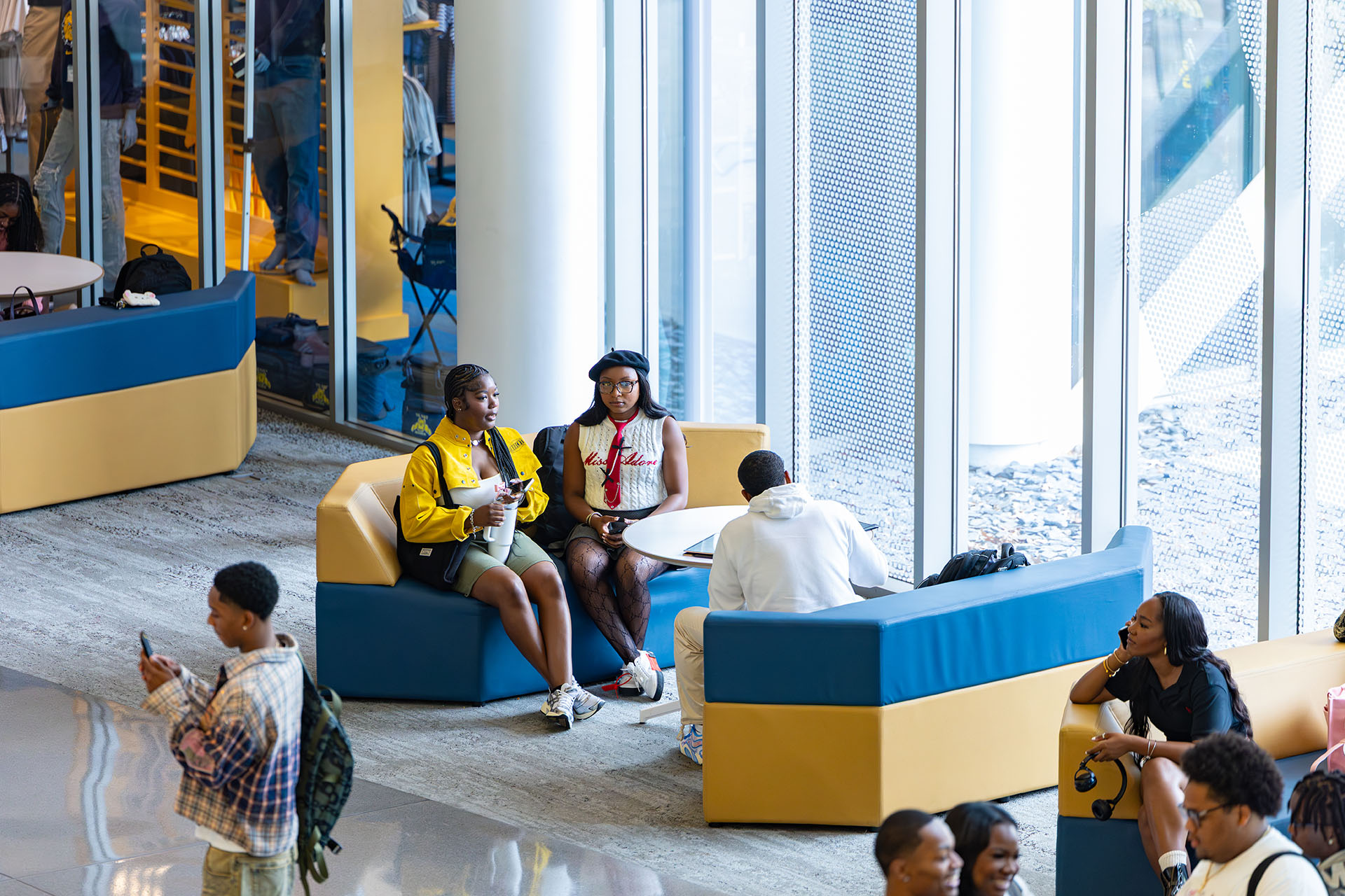 Student lounging in Student Center lobby