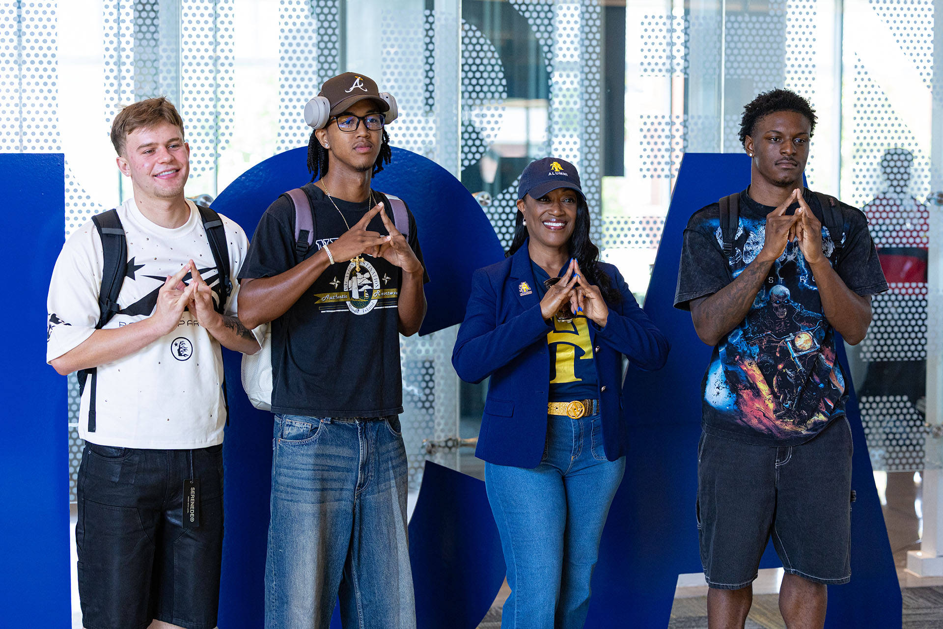 NCAT visitors holding up A&T hand gesture