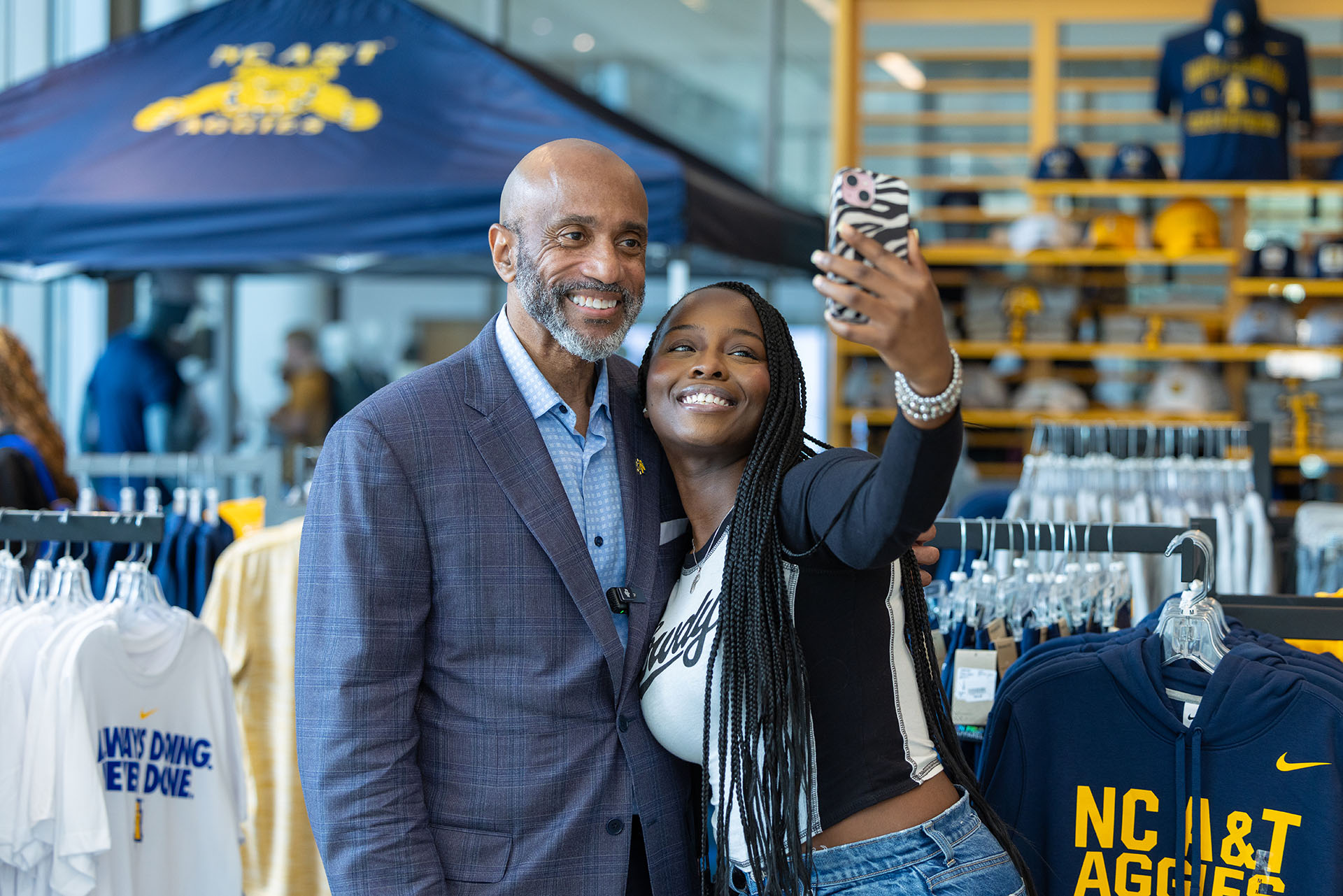 Chancellor Martin taking a selfie with a student in the NCAT Bookstore
