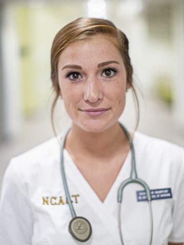 female nursing student in white lab coat
