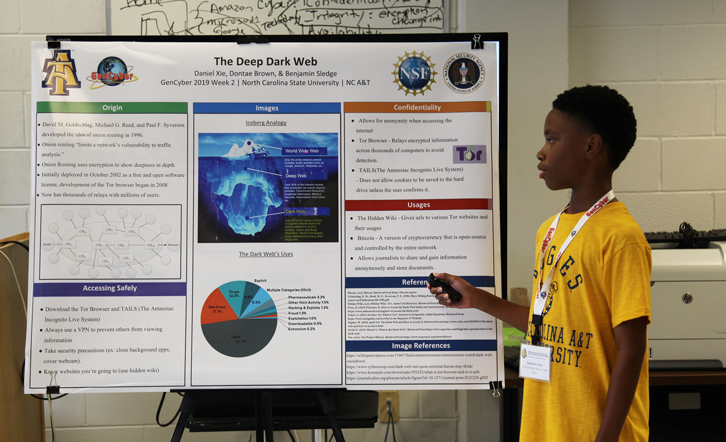 A young student presents a poster at the Gen Cyber camp