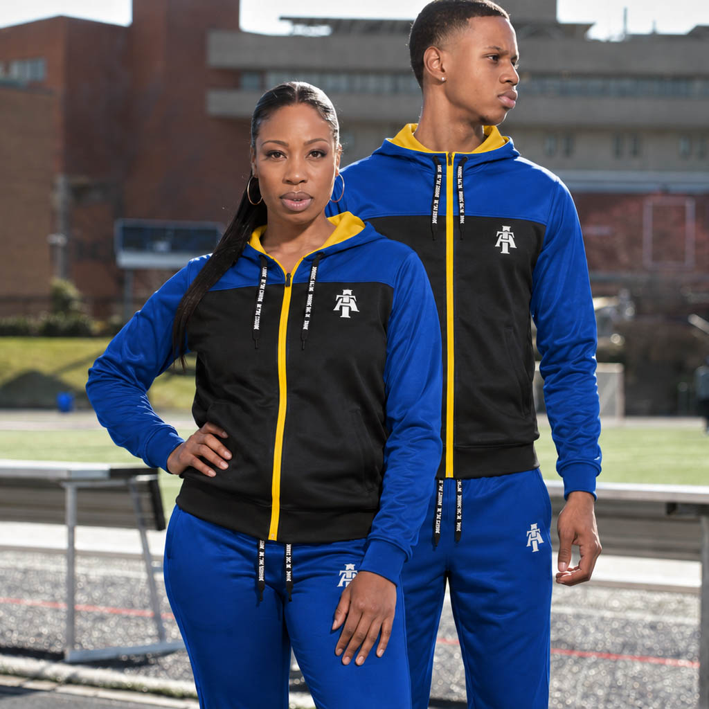 Man and woman wearing track suit with A&T logo