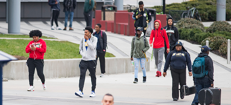 Student walking around campus and heading to class