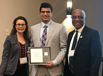 This is a photo of Dr. Sharma accepting the award.