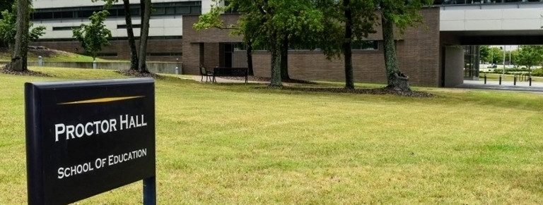 Proctor Hall sign and building
