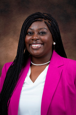 Photo of person with braids and bright colored blazer