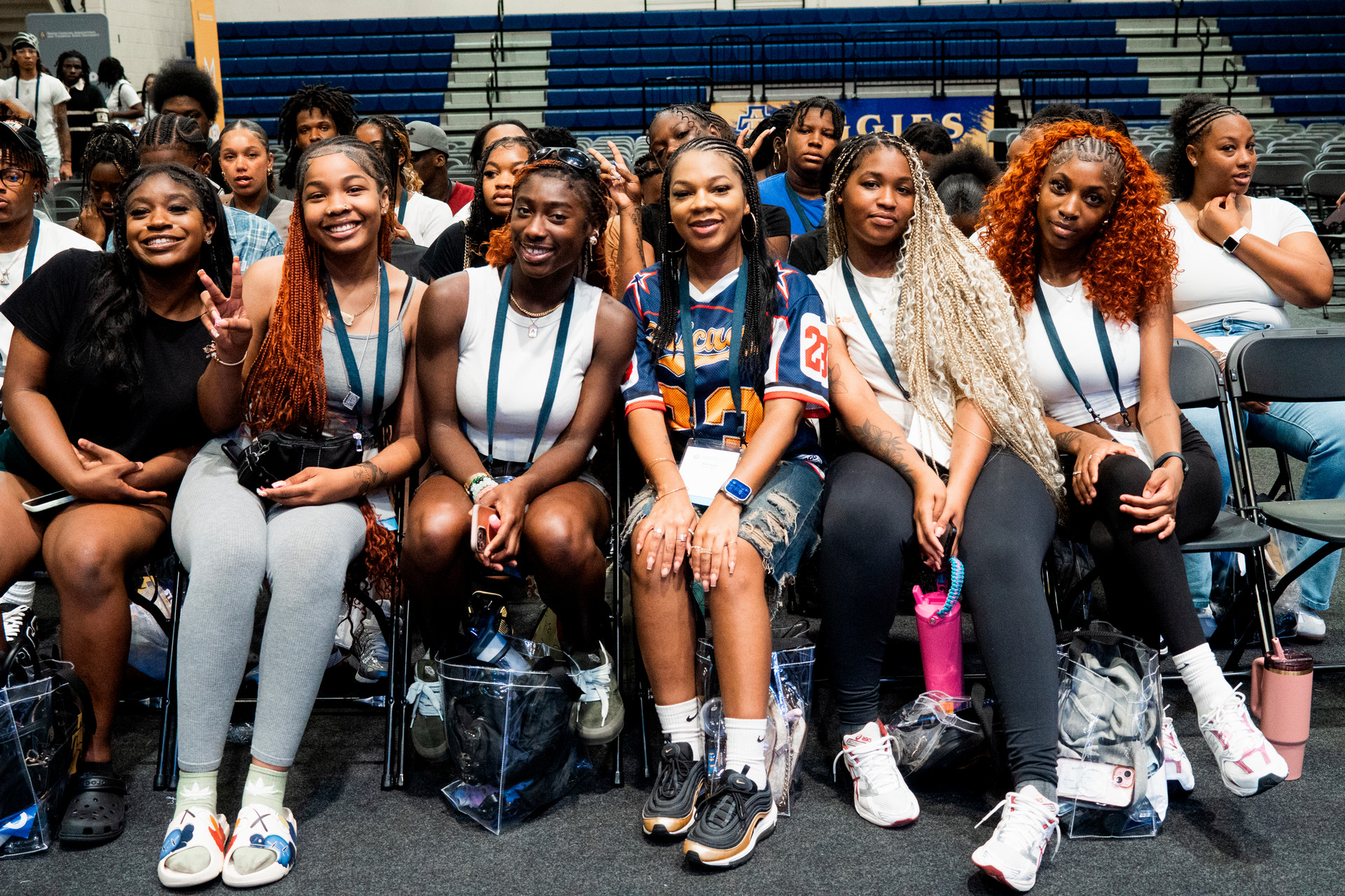 student ambassadors making the aggie hand sign